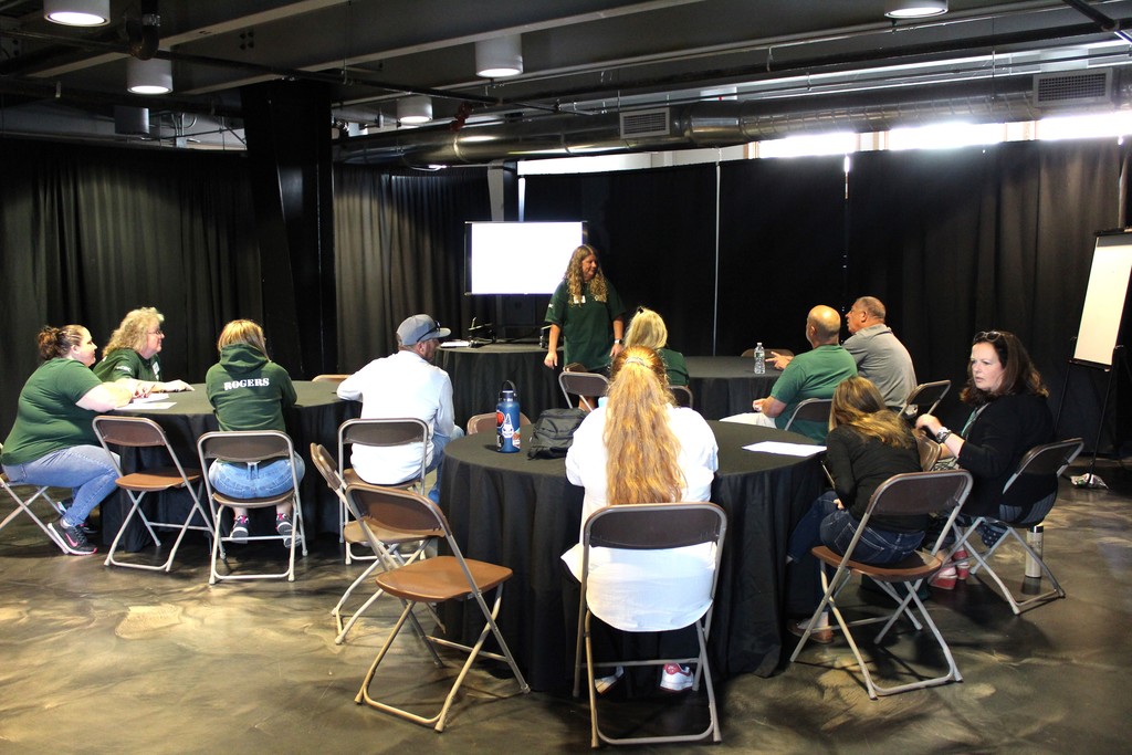 A group of employees sitting at tables during a presentation
