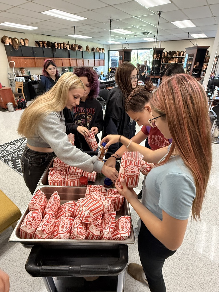 Students in the cosmetology classroom getting popcorn.