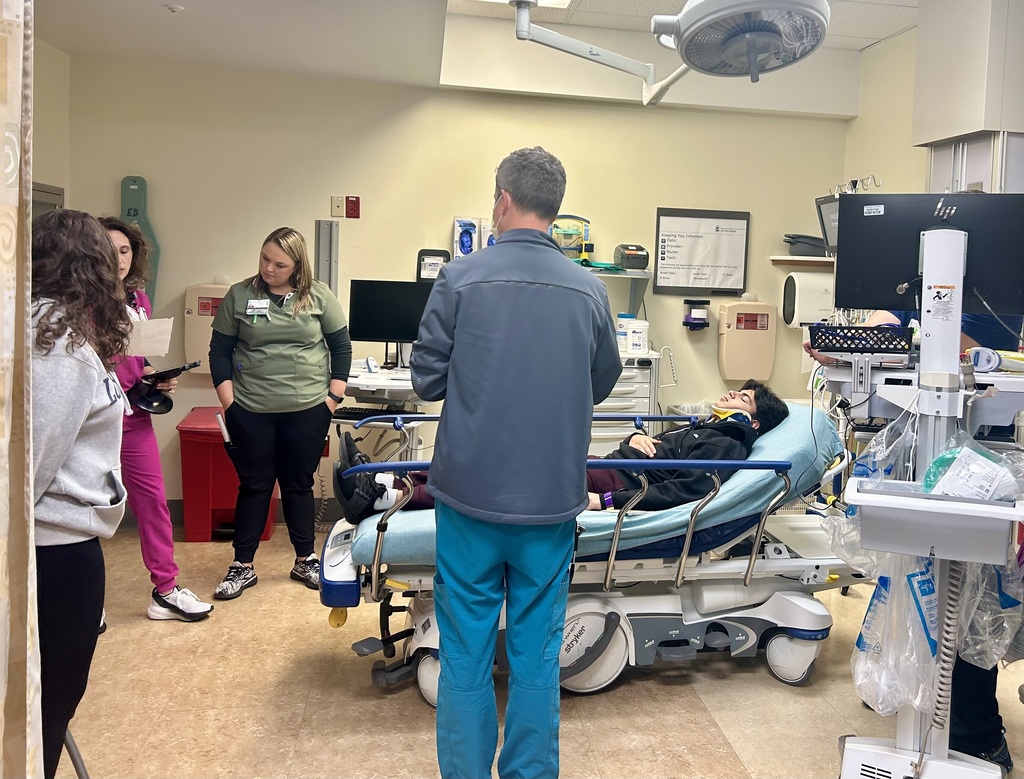 Inside a hospital with 3 staff members and 2 students during the drill. One student in a hospital bed acting as a victim.