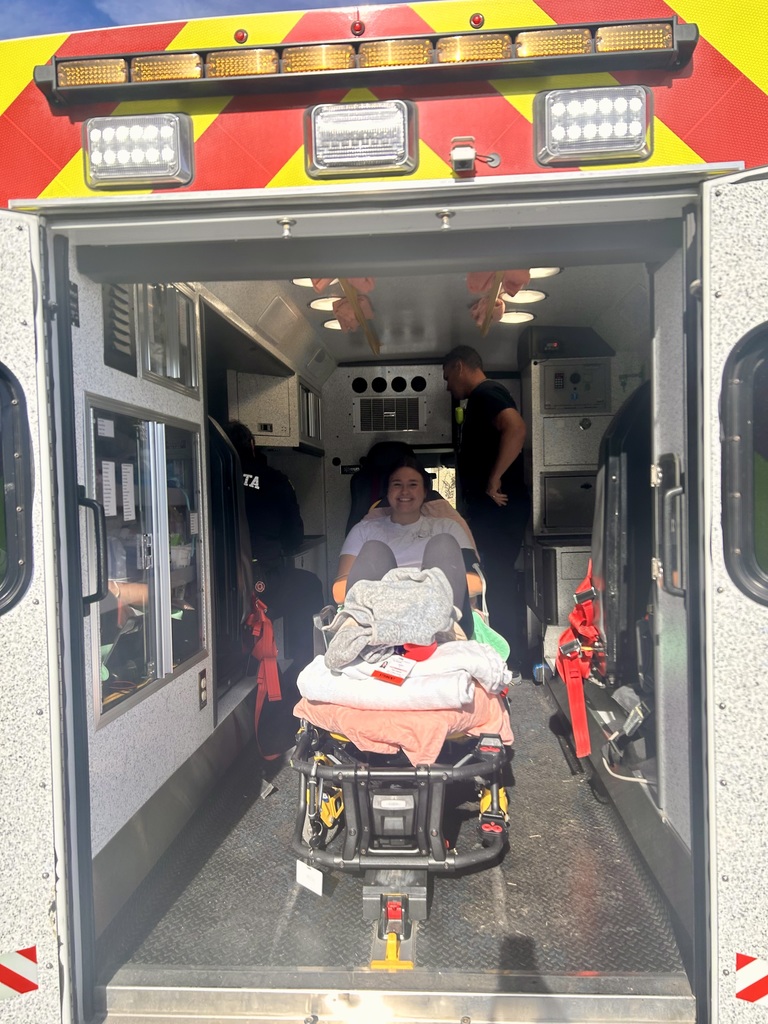 Student acting as victim during the drill in an ambulance