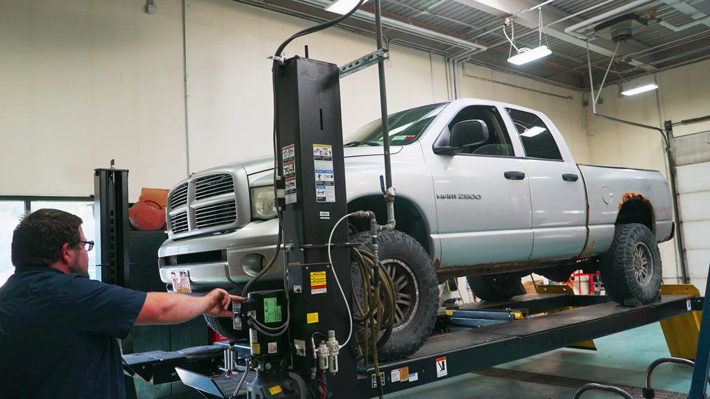 Truck on lift with insructor.