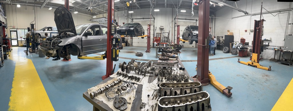 Cars on lifts in shop area