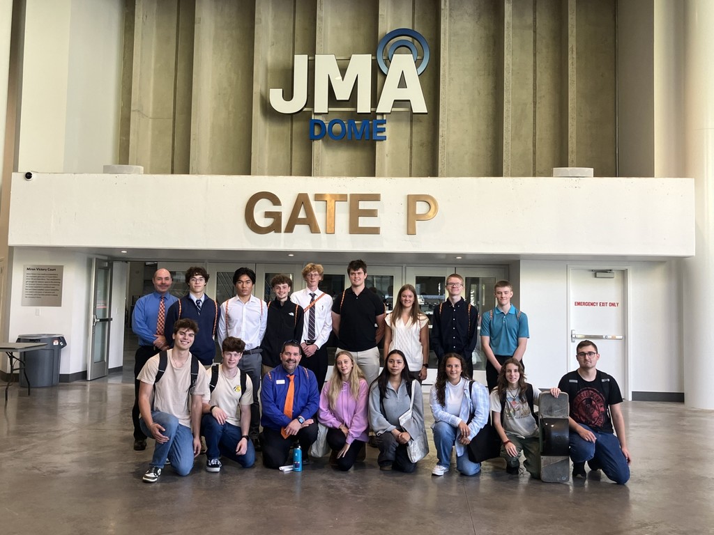 Students, instructor, and alumni outside the Syracuse dome by Gate P