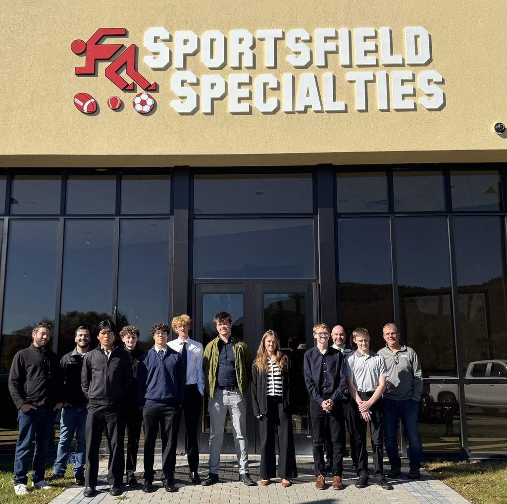 Engineering students, instructor, and staff from Sportsfield Specialties outside the complex