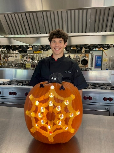 Student with their spider web pumpkin