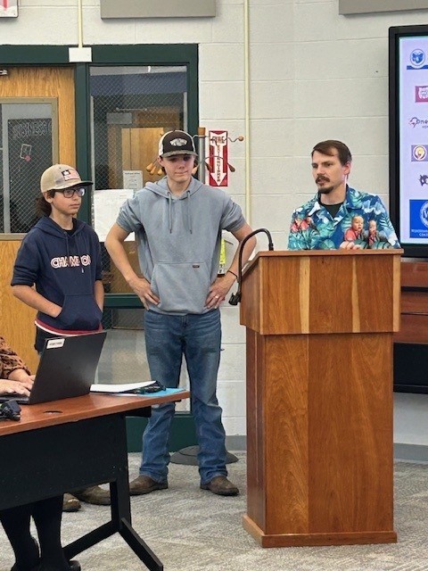 Two students and a staff member presenting at the October board of education meeting
