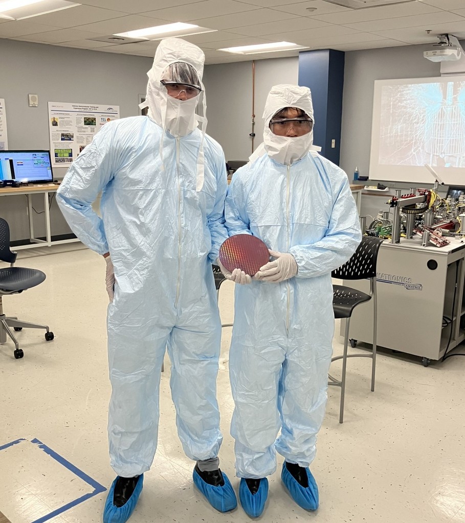 Two students dressed in full personal protection equipment