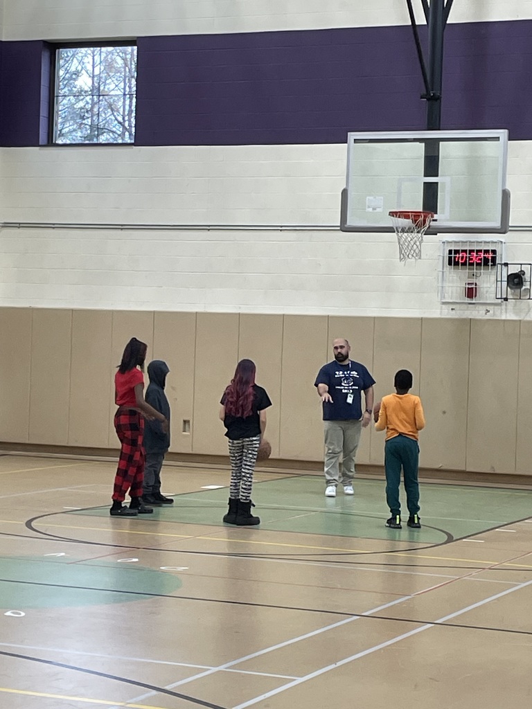 Teacher and 5 students playing basketball