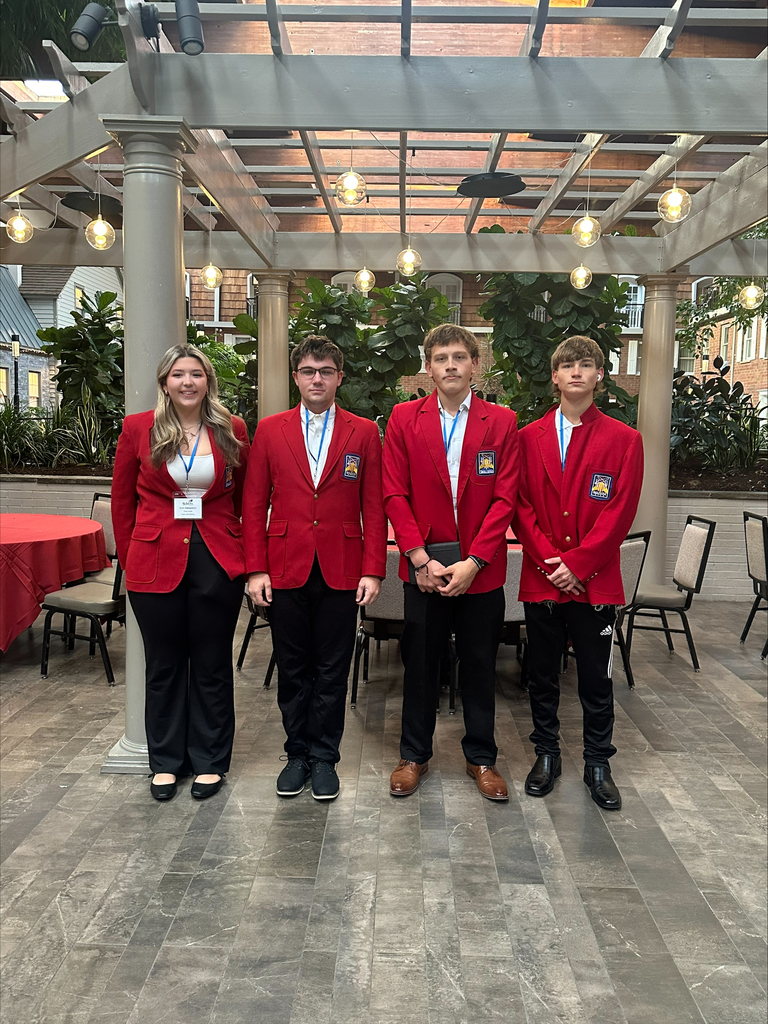 Four students posing in a line at the leadership conference.