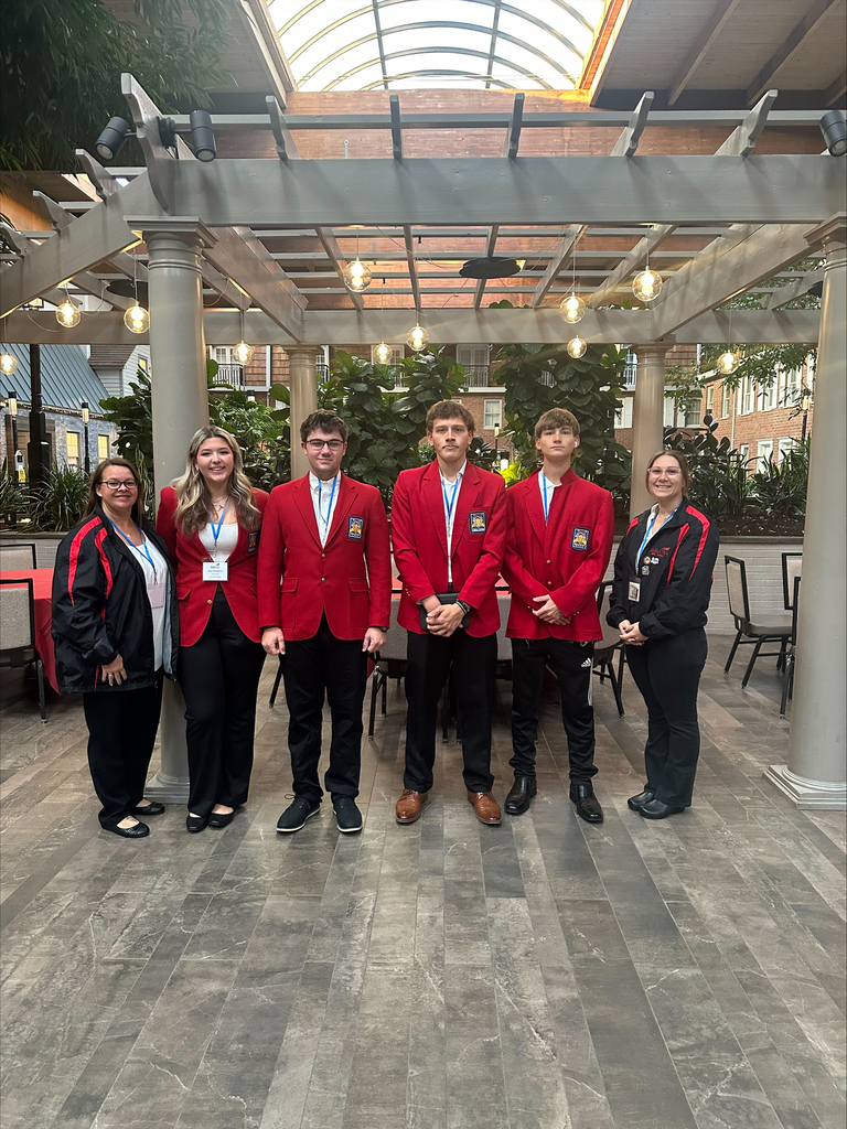 Four students and two advisors posing at the leadership conference
