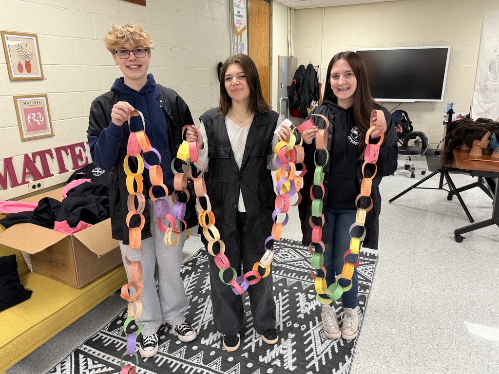 Three high school students with a gratitude chain