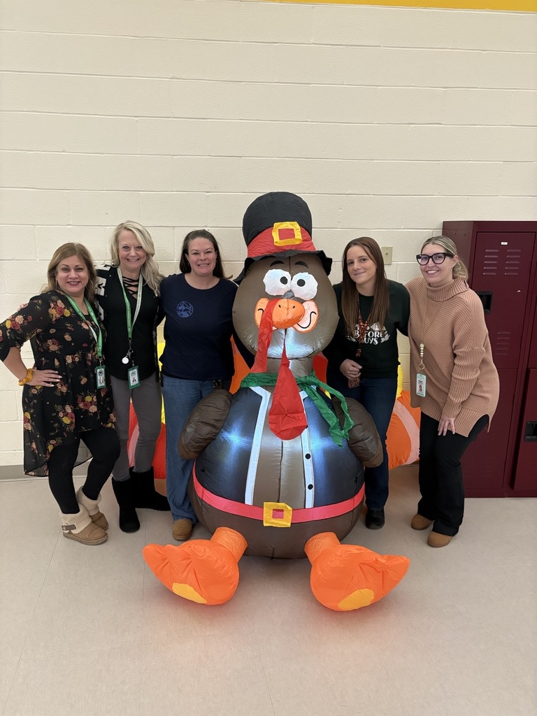 Five staff members standing with the inflatable turkey