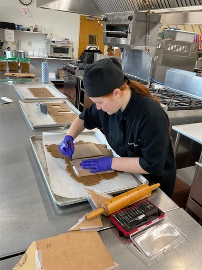 Student cutting out gingerbread