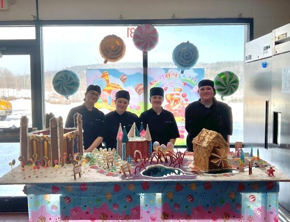 Team candy land - 4 students with their gingerbread creation