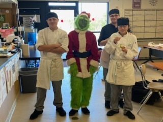 The Grinch with three culinary arts students
