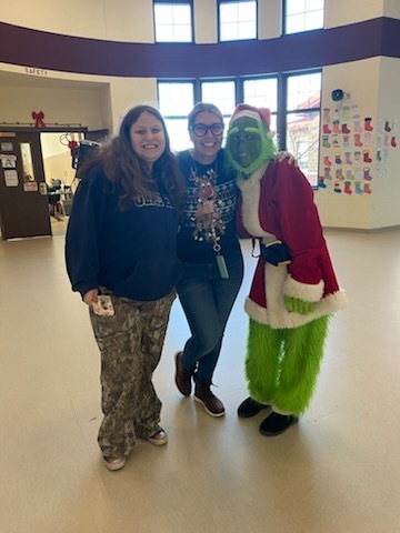 The Grinch with staff member and student