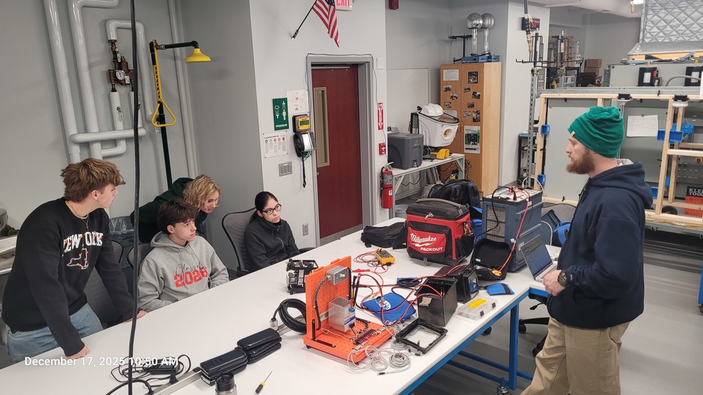 Students working with electronics and Dan Truax from NYSEG