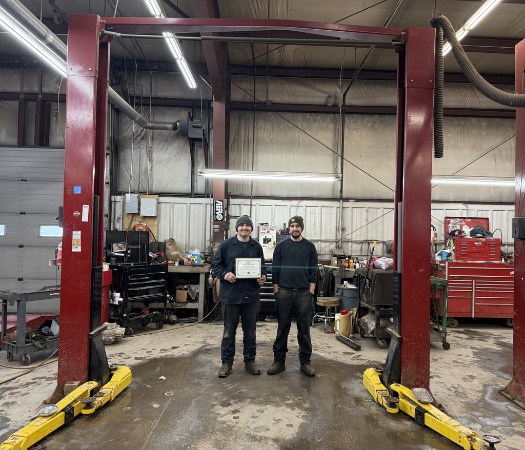 OAOC student and Empire Toyota of ONeonta staff member posing with certificate in auto shop