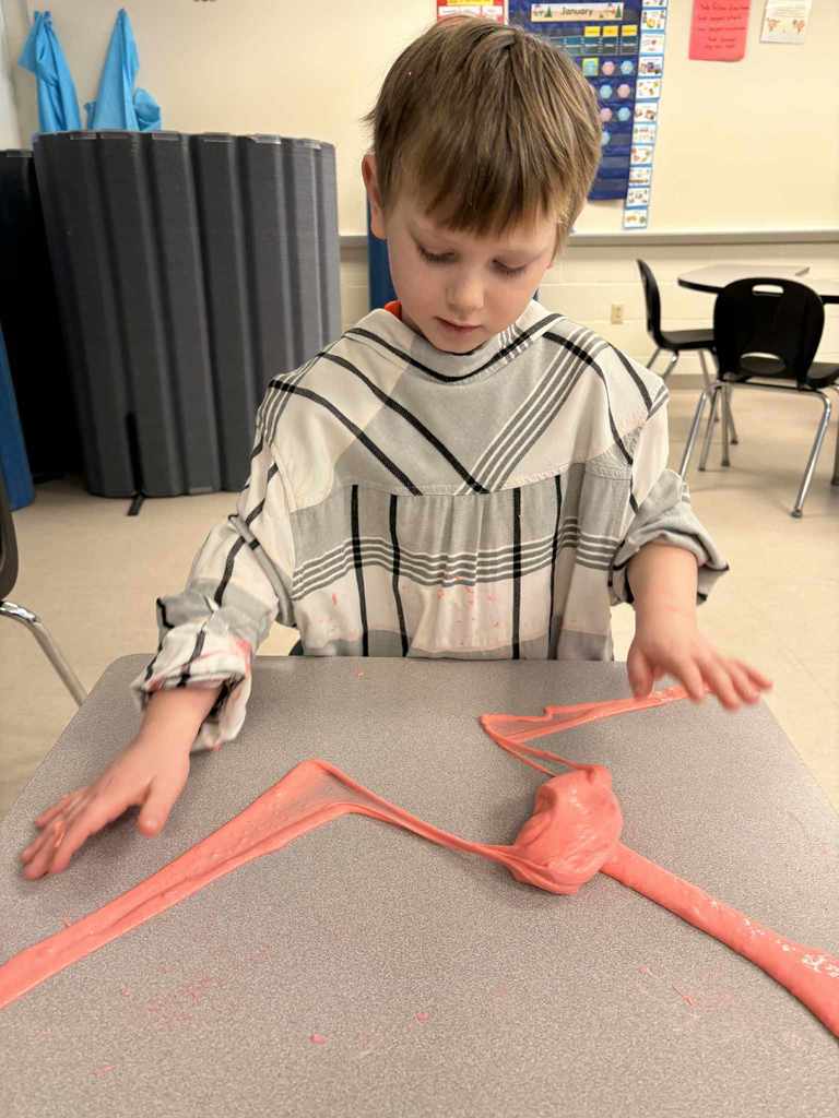 Student stretching and playing with fluffy slime