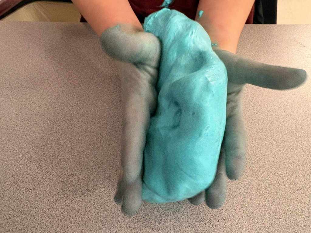 Student hands with fluffy slime