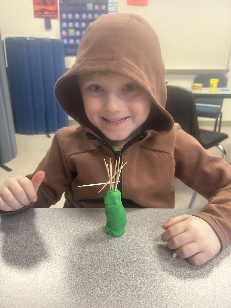 Young student during STEM Friday creating a tower out of playdough and toothpicks