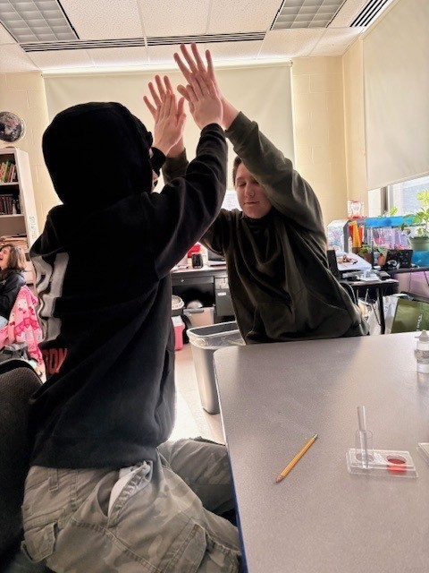 Two students giving each other a high five