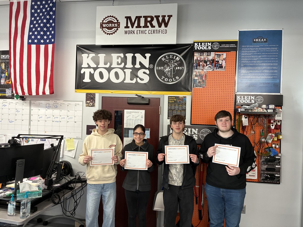 Four mechatronics students posing with their certificates