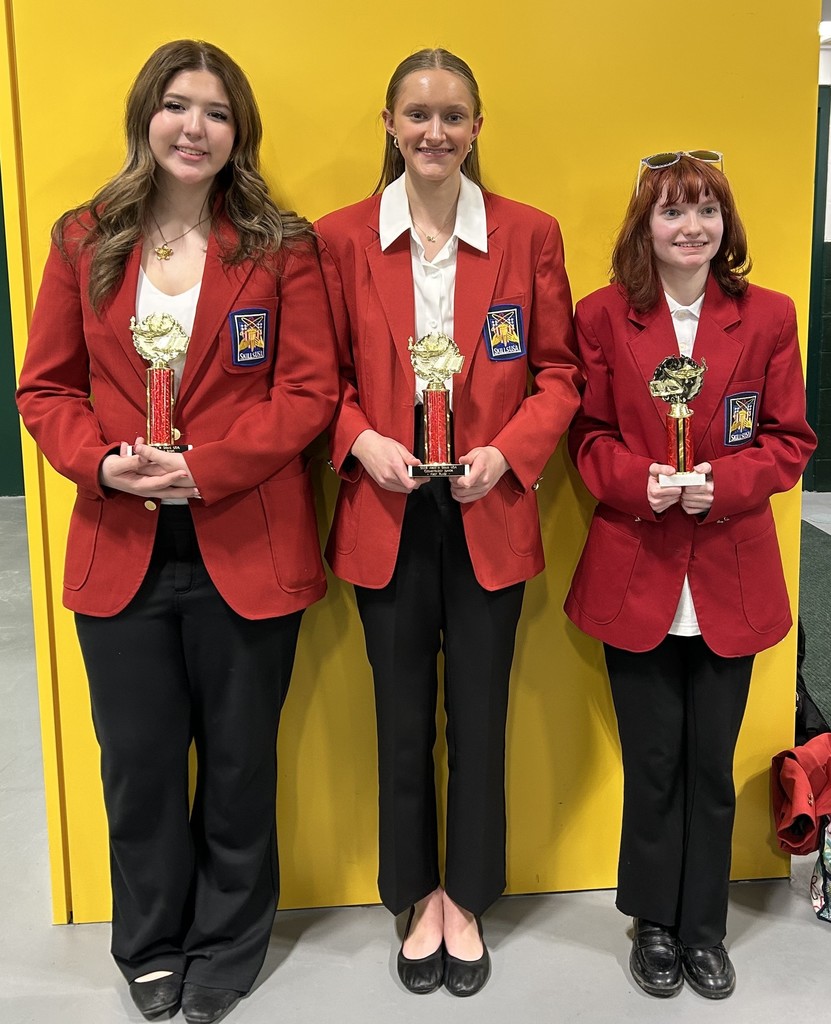 Three Skills members holding trophies
