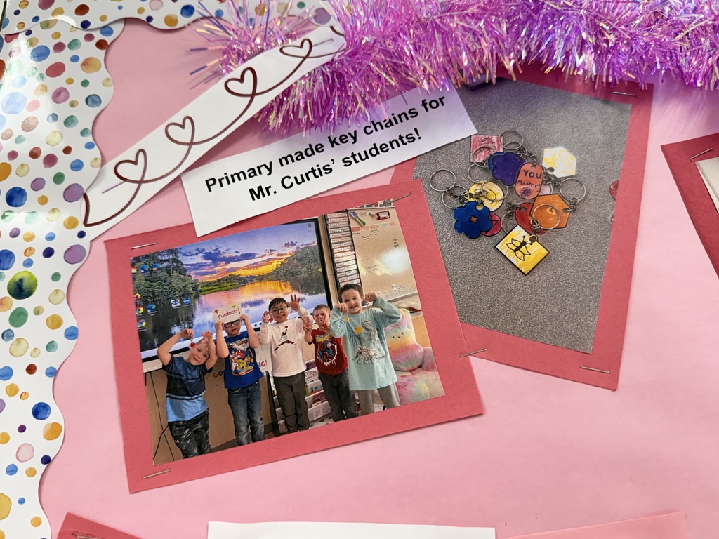 Pictures on bulletin board: One of 5 elementary students and one of keychains they made. Caption says Primary made key chains for Mr. curtis' students
