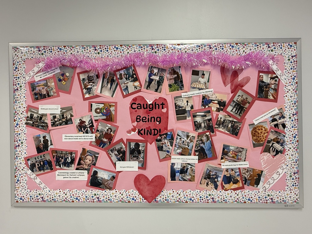 Large bulletin board with pictures of students and staff being kind. Red heart in the middle says Caught Being Kind
