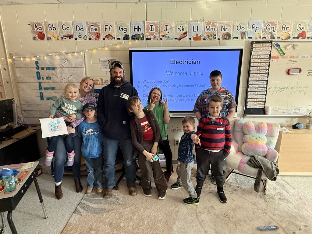 Group of elementary students and teacher with guest speaker, Hank, Electrician.