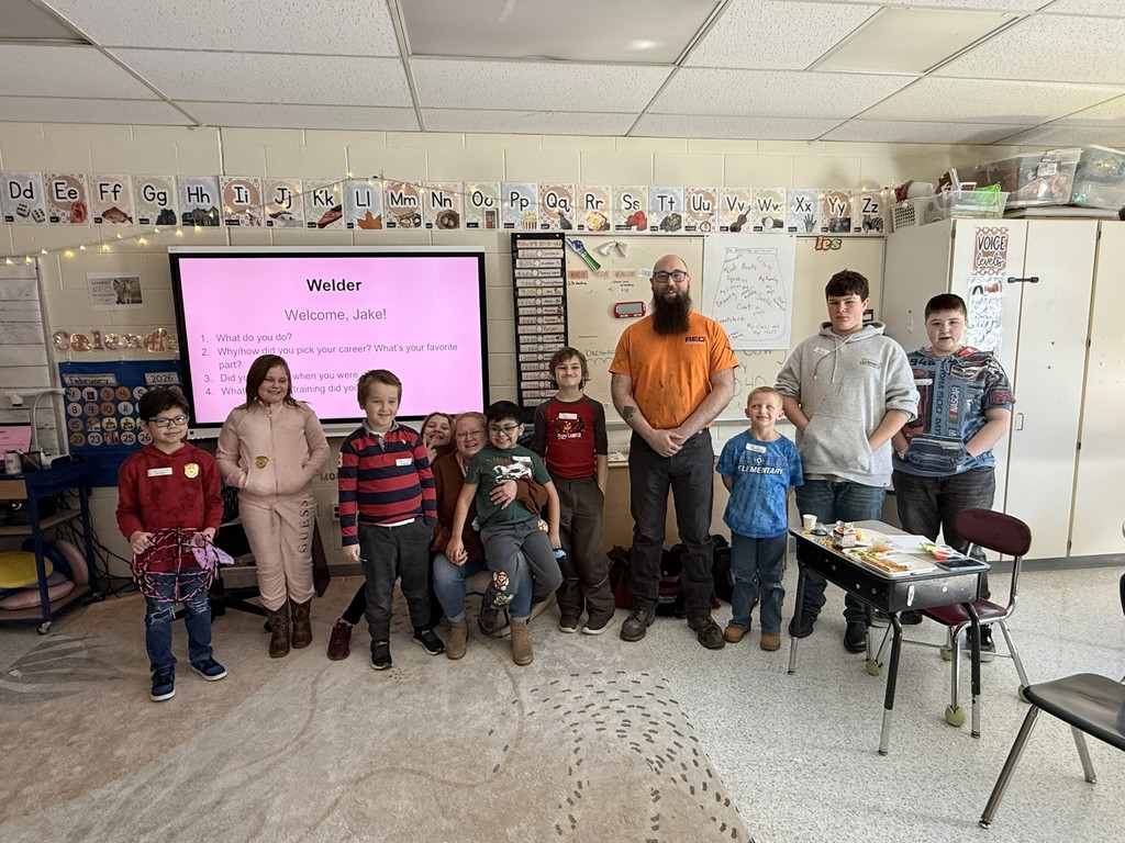 Group of elementary students and teacher with guest speaker, Jake, Welder