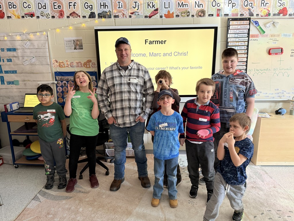 Group of elementary students and teacher with guest speaker, Marc, Farmer.