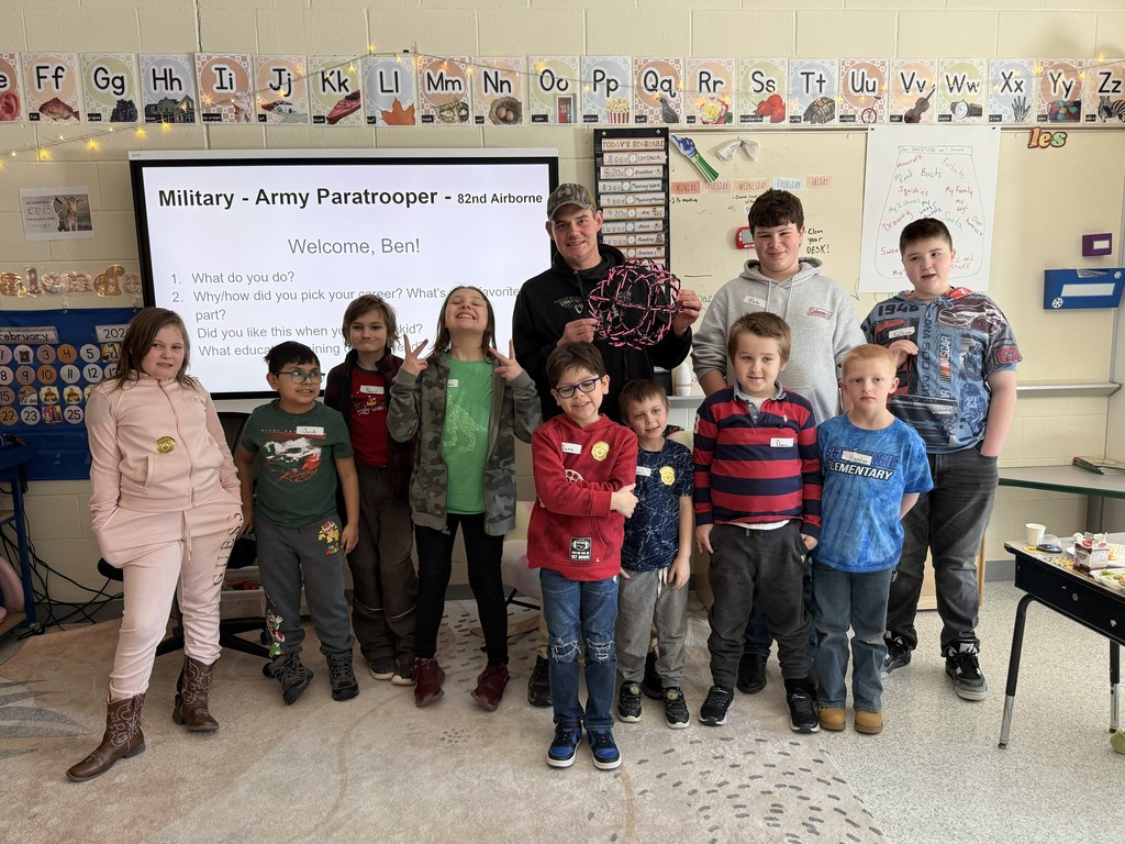 Group of elementary students and teacher with guest speaker, Ben, Paratrooper