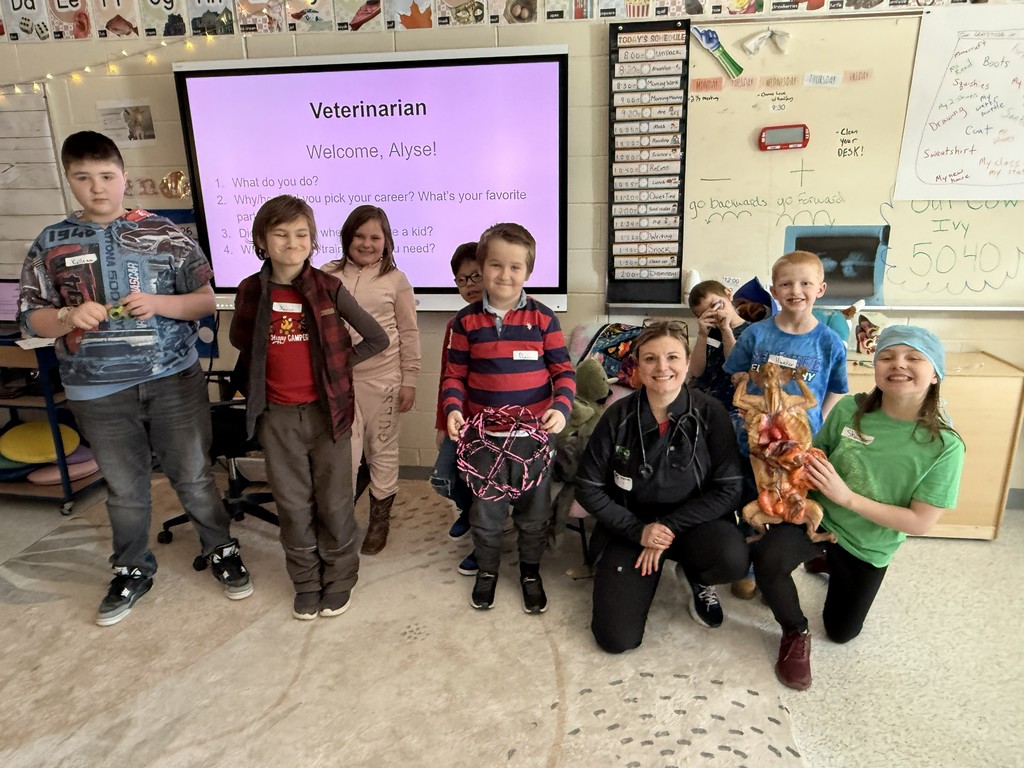 Group of elementary students and teacher with guest speaker, Alyse, Veterinarian 