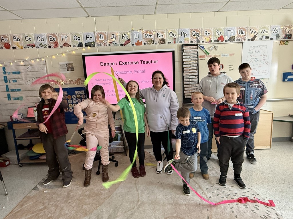 Group of elementary students and teacher with guest speaker, Edna, Dance Teacher