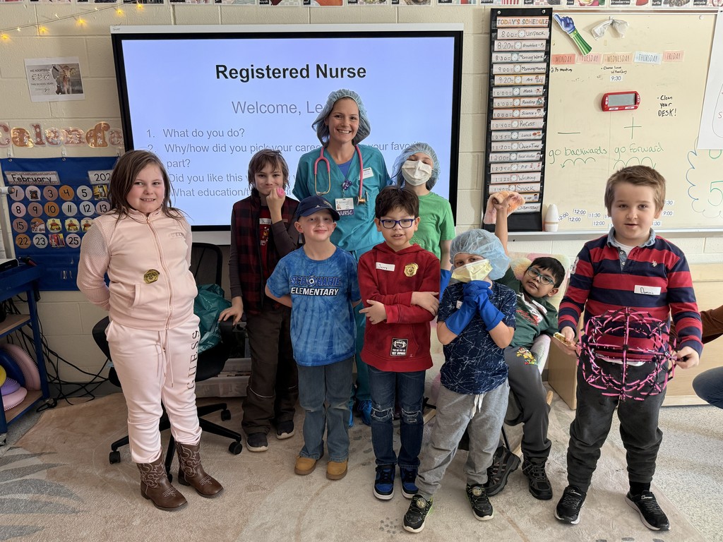 Group of elementary students and teacher with guest speaker, Leann, Registered Nurse