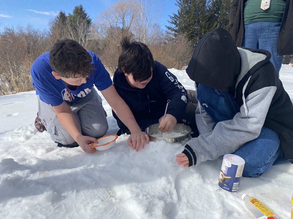 Three students outside working with snow and salt