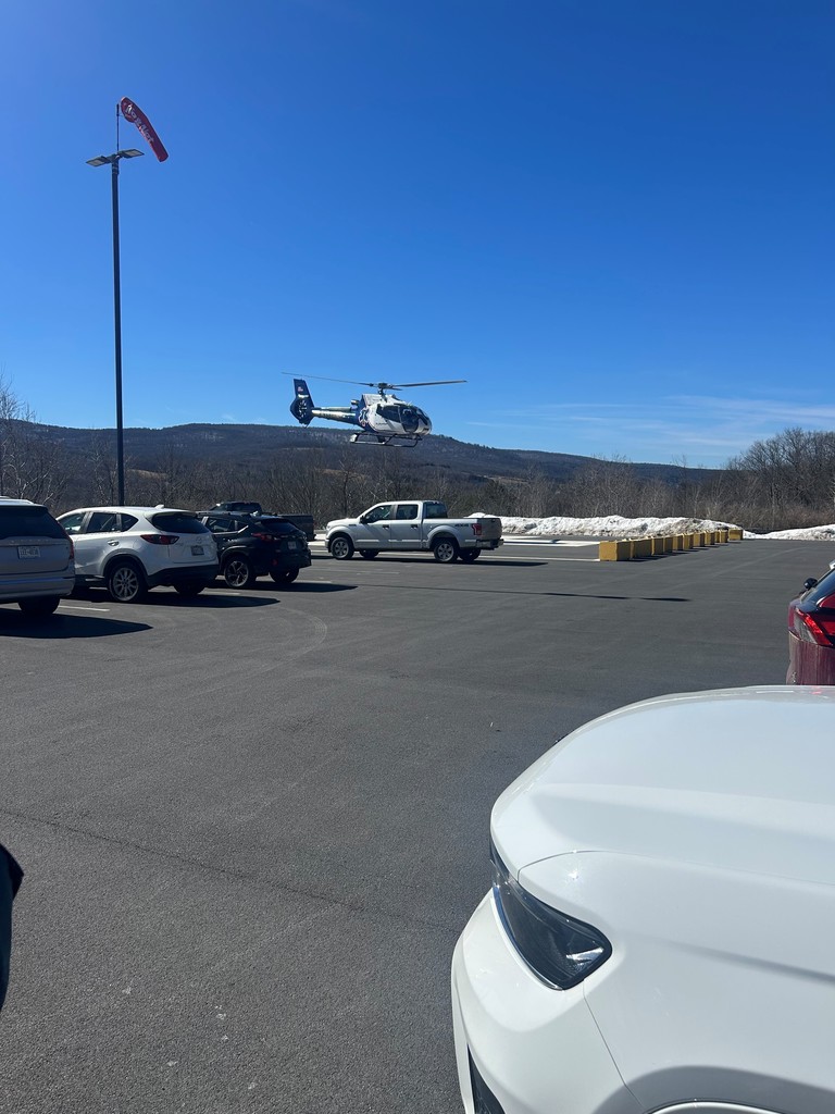 Helicopter above a parking lot getting ready to land