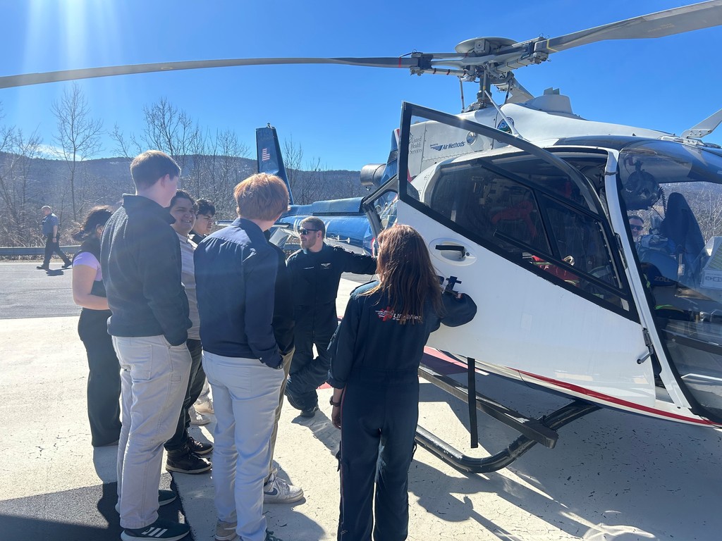 Lifenet helicopter pilots and students standing out side the helicopter talking