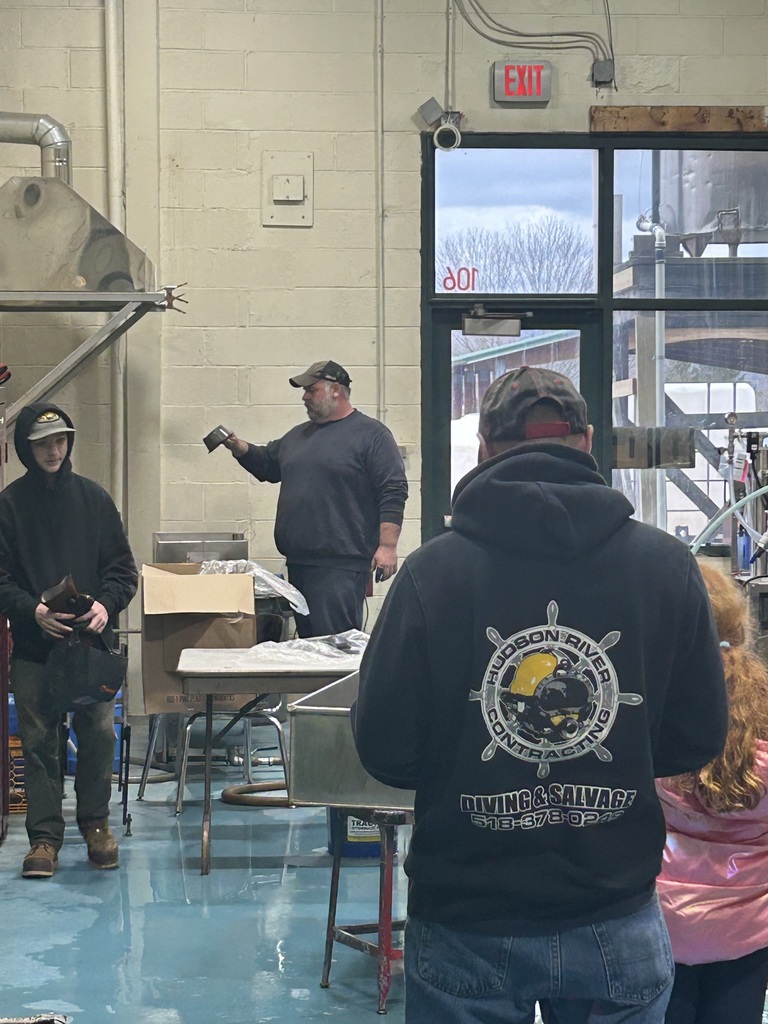 Students and adults in the Equipment Operation Repair area with the instructor