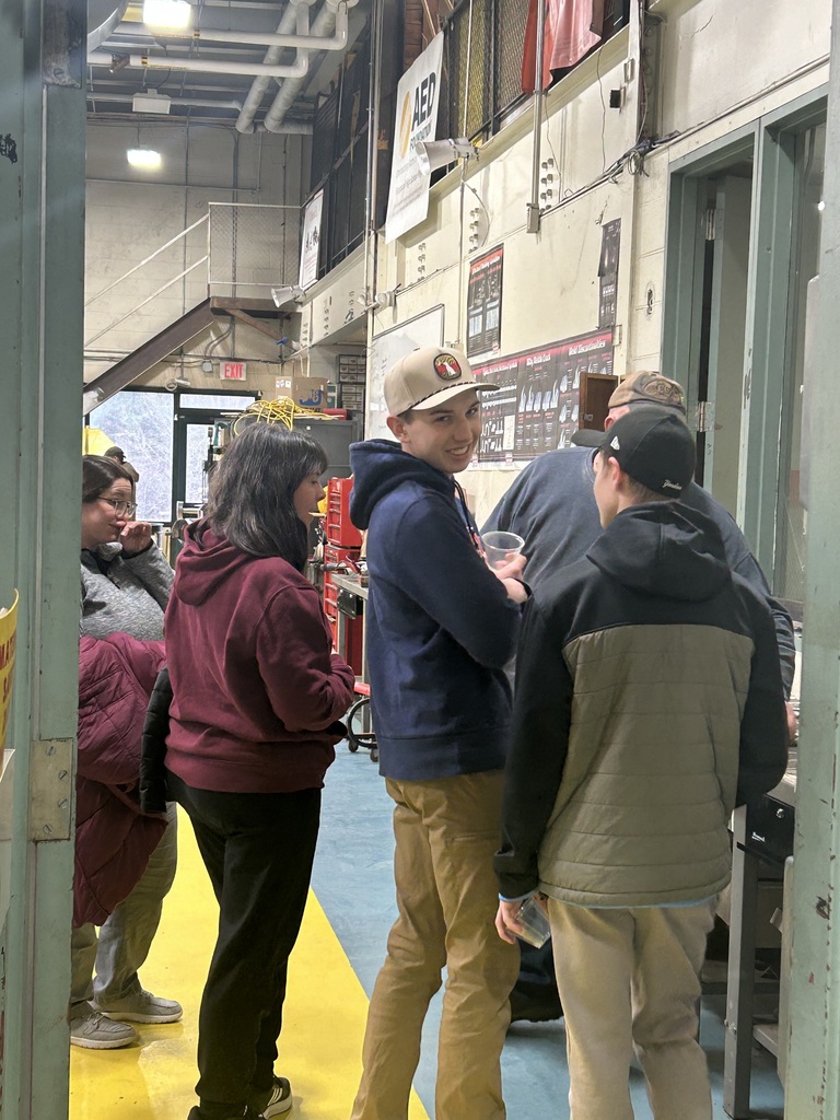 Students and adults in the Equipment Operation and Repair area