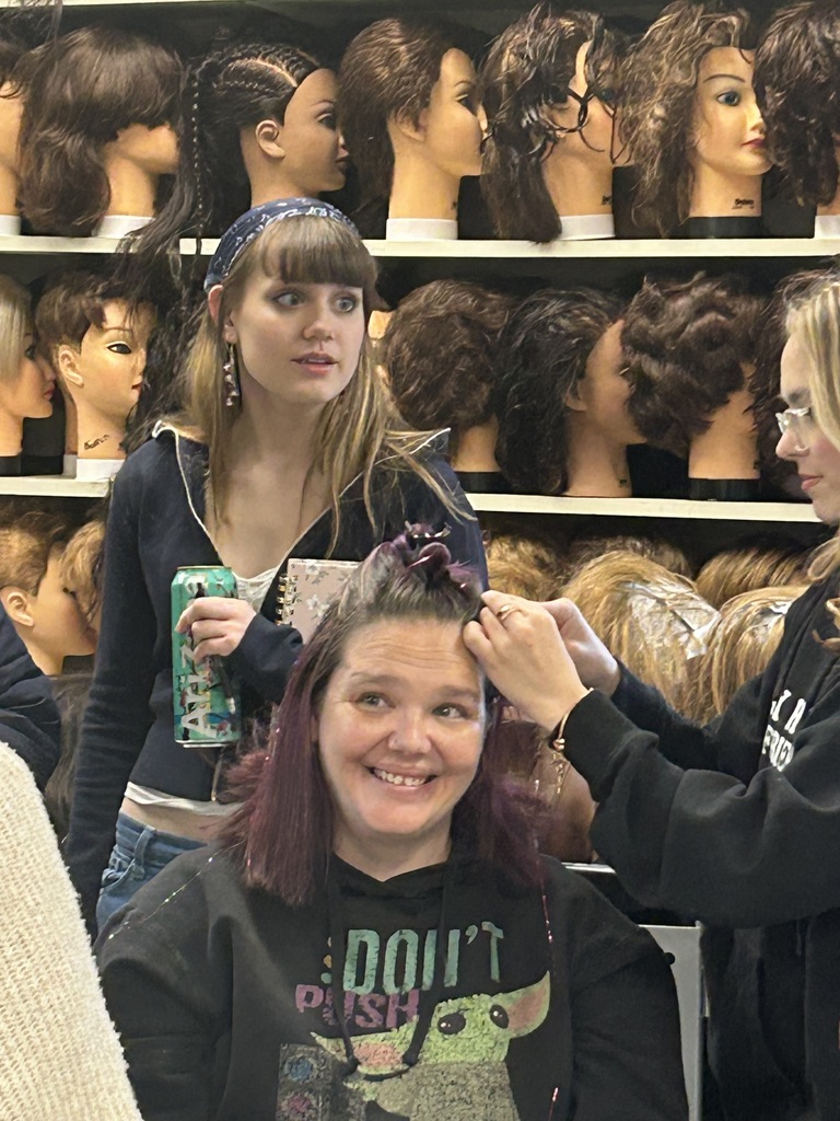 Cosmetology student working on hair of someone