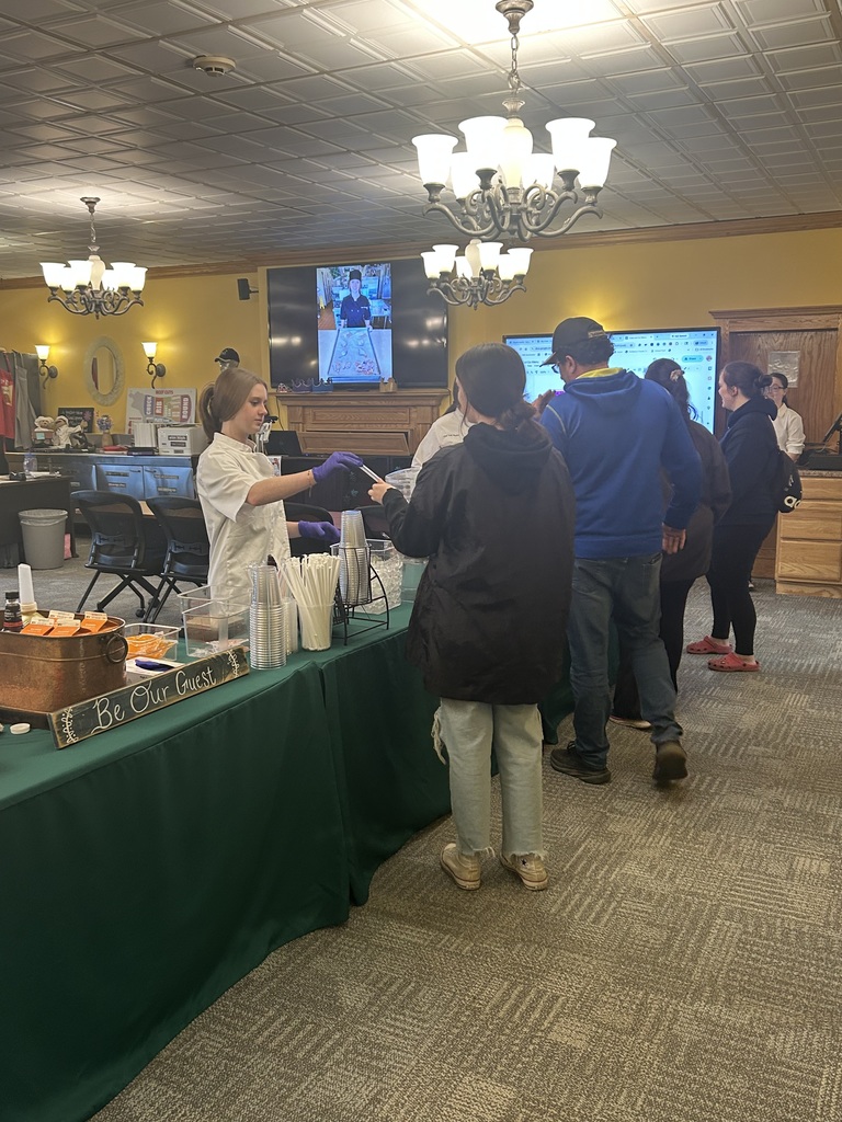 Culinary student providing drinks to people in line