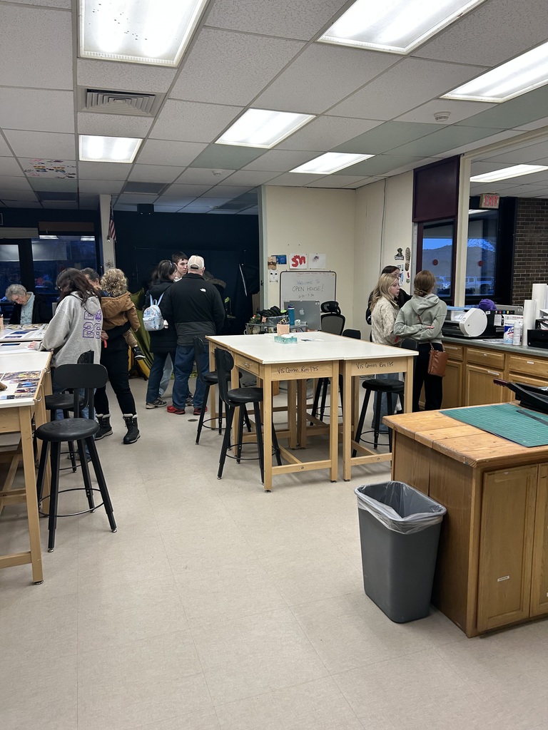 Students and adults in a classroom at OAOC