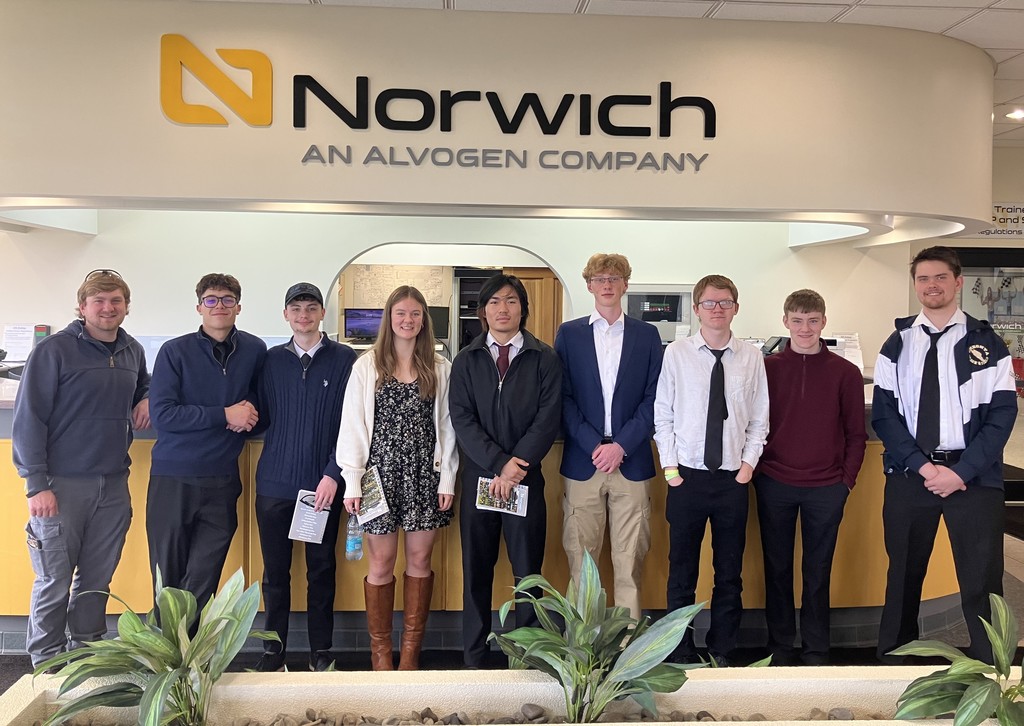 9 students standing in front of Norwich An Alvogen Company sign