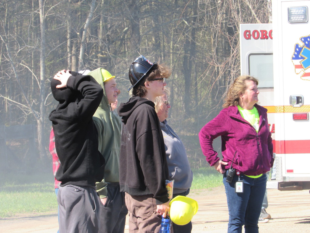Three high school students and two staff members standing near the Grand Gorge EMT truck watching