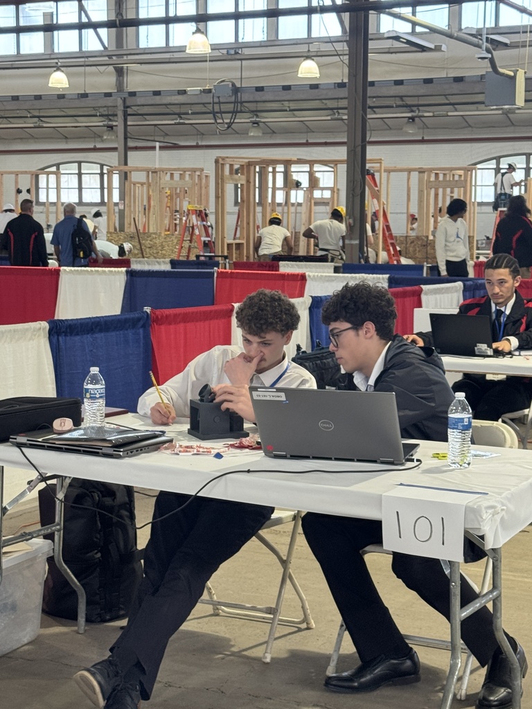 Two students sitting at a table with a laptop