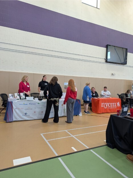 Staff member and student at a business' table.