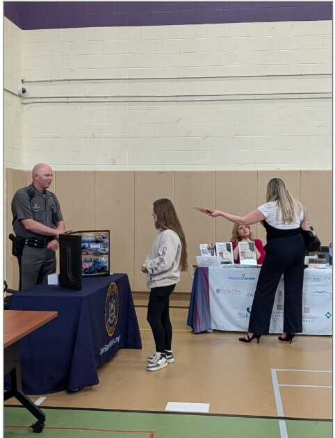 A student speaking with a New York State Trooper